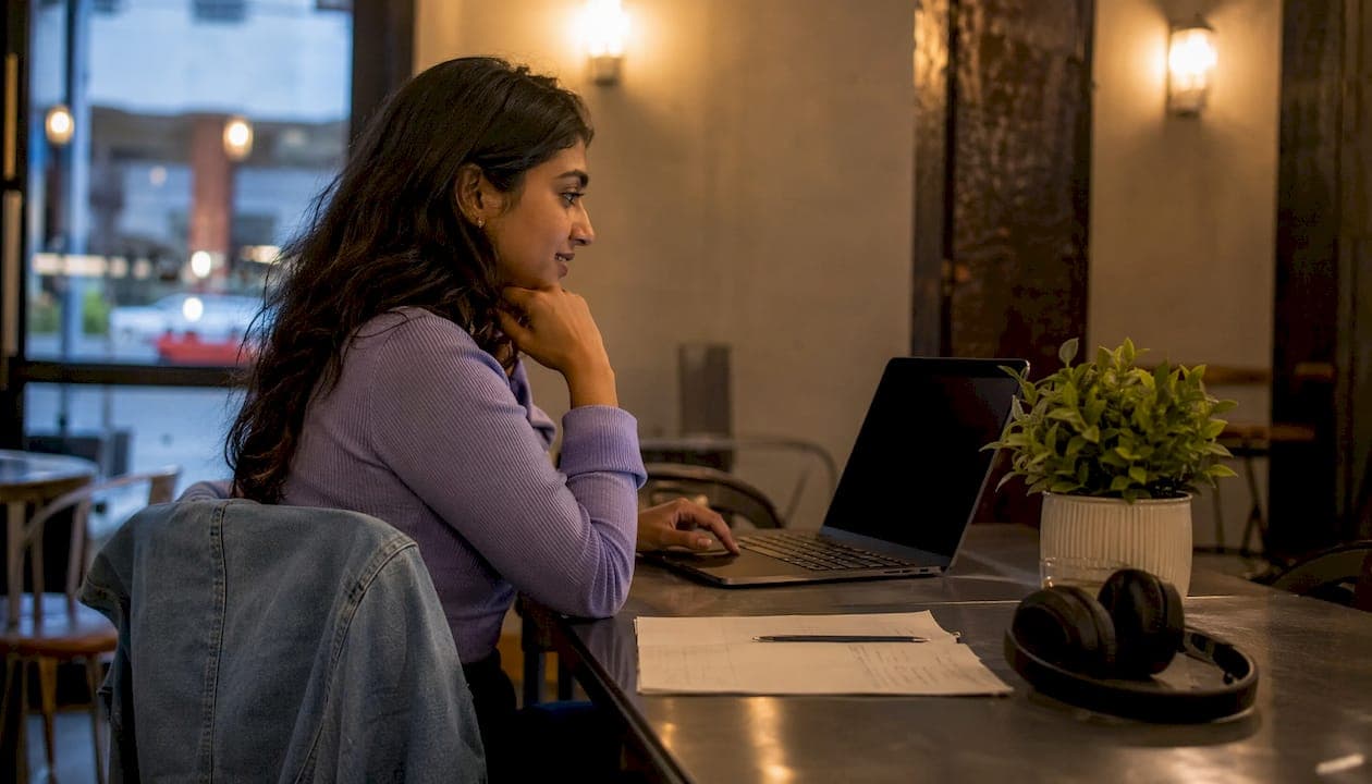 Woman watching onboarding video at desk